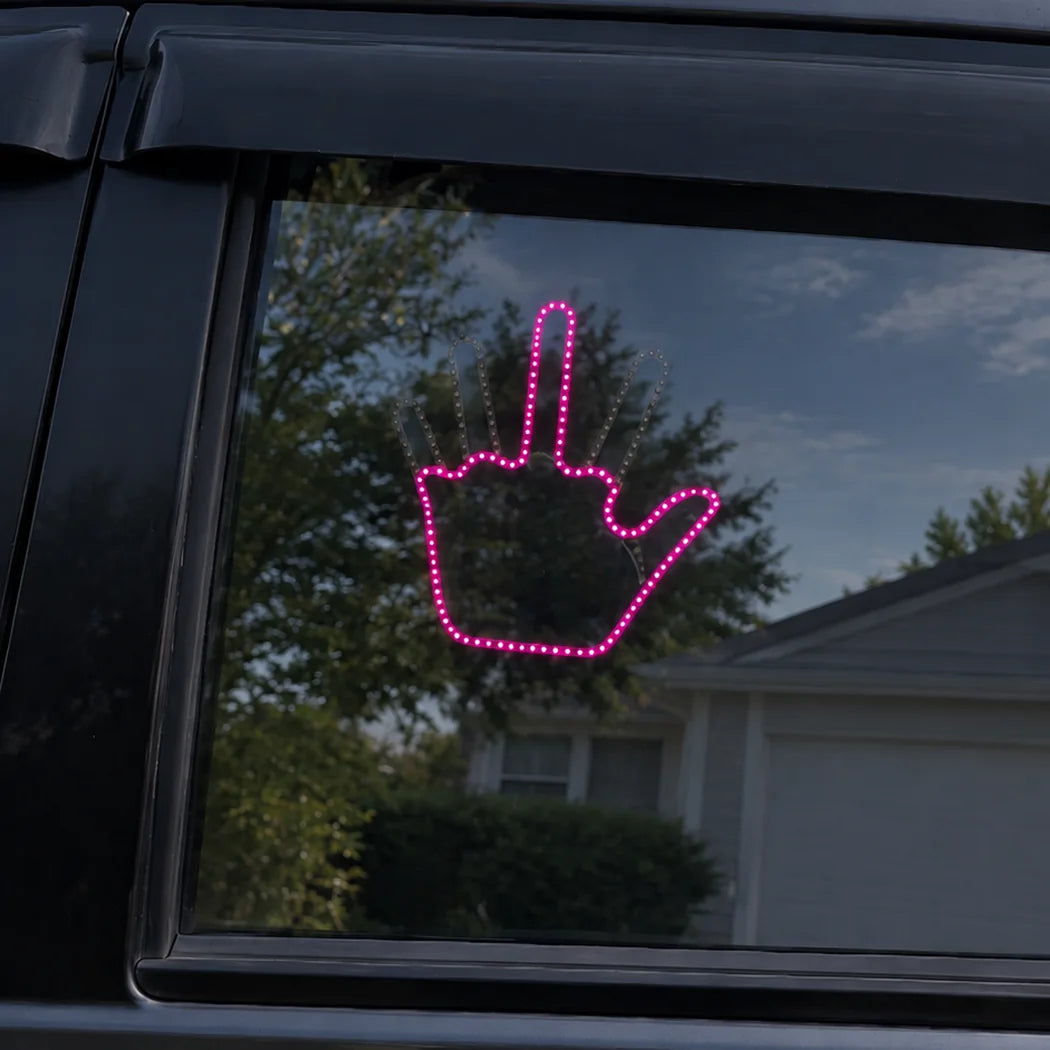 Magenta Glo Sign illuminated on vehicle window